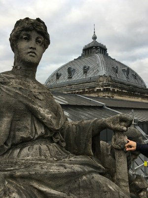 statue sur la toiture de al bourse avec la coupole en arrière-plan